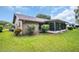 This backyard features a well-maintained lawn, lush landscaping, and a screened lanai, perfect for outdoor enjoyment at 2608 Camille Dr, Palm Harbor, FL 34684
