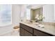 Bright bathroom featuring a vanity with a white countertop and a framed mirror with vanity lights at 2608 Camille Dr, Palm Harbor, FL 34684