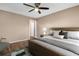 Spacious bedroom with hardwood floors, large window, lamp on a nightstand, and a sitting chair at 2608 Camille Dr, Palm Harbor, FL 34684