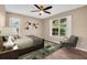 Cozy bedroom with a ceiling fan, a large window and hardwood floors at 2608 Camille Dr, Palm Harbor, FL 34684