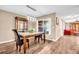 A dining room with a decorative lighting fixture, a marble table and a hutch at 2608 Camille Dr, Palm Harbor, FL 34684
