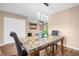The dining room features a marble table, pendant lighting, and laminate floors at 2608 Camille Dr, Palm Harbor, FL 34684