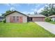 Charming single-story home with brick accents, well-maintained lawn, and two-car garage at 2608 Camille Dr, Palm Harbor, FL 34684