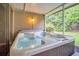 Relaxing hot tub on screened lanai for ultimate backyard oasis at 2608 Camille Dr, Palm Harbor, FL 34684