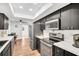 Well-lit kitchen features sleek black cabinets, stainless steel appliances, and white countertops at 2608 Camille Dr, Palm Harbor, FL 34684