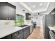Bright kitchen features black cabinets, stainless appliances, laminate countertops, and a window over the sink at 2608 Camille Dr, Palm Harbor, FL 34684