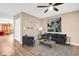A spacious living room with neutral colors, a ceiling fan, and light laminate floors at 2608 Camille Dr, Palm Harbor, FL 34684