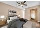 Serene bedroom featuring a ceiling fan, warm color palette and stylish decor at 2608 Camille Dr, Palm Harbor, FL 34684