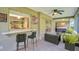 Outdoor bar counter and comfortable seating area on screened lanai with a hot tub at 2608 Camille Dr, Palm Harbor, FL 34684