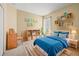 Cozy bedroom with blue bedding, books, and a desk at 27353 Edenfield Dr, Wesley Chapel, FL 33544