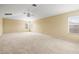Expansive carpeted bedroom with large windows and ceiling fan at 27353 Edenfield Dr, Wesley Chapel, FL 33544