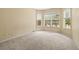 Bright bedroom with carpeted floor, large windows, and neutral paint at 27353 Edenfield Dr, Wesley Chapel, FL 33544