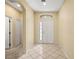 Bright foyer with tile flooring, a decorative window above the door, and ample natural light at 27353 Edenfield Dr, Wesley Chapel, FL 33544