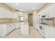 Functional kitchen with white cabinetry, tile floors, and ample counter space for cooking and meal preparation at 27353 Edenfield Dr, Wesley Chapel, FL 33544