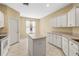 Bright kitchen with a center island, lots of cabinets, and a window creating a welcoming cooking space at 27353 Edenfield Dr, Wesley Chapel, FL 33544