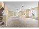 Spacious living room with neutral carpet, large windows with backyard views, and an open floor plan at 27353 Edenfield Dr, Wesley Chapel, FL 33544