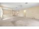Bright and open living area with carpet, soft yellow walls and archways creating a nice flow to the kitchen at 27353 Edenfield Dr, Wesley Chapel, FL 33544