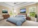 Serene main bedroom with tray ceiling, neutral colors, and large windows filling the room with light at 27353 Edenfield Dr, Wesley Chapel, FL 33544