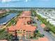 Scenic aerial view of orange terracotta roofed condos situated on canal with community boat docks at 2741 Via Cipriani # 934B, Clearwater, FL 33764