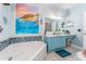 Bathroom with soaking tub, vanity with bowl sink, and themed decor for a relaxing ambiance at 2741 Via Cipriani # 934B, Clearwater, FL 33764