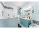 Bright bathroom features a glass-enclosed shower, vanity with bowl sink, and coordinated decor at 2741 Via Cipriani # 934B, Clearwater, FL 33764
