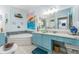 Inviting bathroom with vanity, soaking tub, and unique decorative elements at 2741 Via Cipriani # 934B, Clearwater, FL 33764