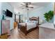 Comfortable bedroom with wood floors, decorative ceiling fan, and abundant natural light at 2741 Via Cipriani # 934B, Clearwater, FL 33764