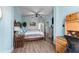 Comfortable bedroom features wood-look flooring, a ceiling fan, and a relaxing ambiance at 2741 Via Cipriani # 934B, Clearwater, FL 33764