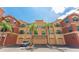 Three-story condo building with garages, palm trees, and well-maintained landscaping at 2741 Via Cipriani # 934B, Clearwater, FL 33764