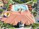 Aerial view of clubhouse featuring pool with chairs and a community center at 2741 Via Cipriani # 934B, Clearwater, FL 33764