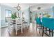 Bright dining area featuring a modern chandelier, breakfast bar, and large windows at 2741 Via Cipriani # 934B, Clearwater, FL 33764