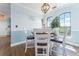 Bright dining area features wood floors, a round table, and large windows with lovely neighborhood views at 2741 Via Cipriani # 934B, Clearwater, FL 33764