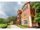 Beautiful terracotta condo exterior showcasing balconies, elegant architectural features and manicured landscaping at 2741 Via Cipriani # 934B, Clearwater, FL 33764