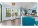 Stylish kitchen area with blue cabinets, wood floors, lots of natural light, and modern appliances at 2741 Via Cipriani # 934B, Clearwater, FL 33764
