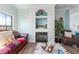 Cozy living room with a beautiful fireplace, wood flooring, and stylish decor at 2741 Via Cipriani # 934B, Clearwater, FL 33764