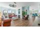 Open-concept living room featuring a fireplace, wood floors and bright, airy windows at 2741 Via Cipriani # 934B, Clearwater, FL 33764