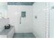 Modern walk-in shower with white subway tile, a built-in bench, and niche storage at 2741 Via Cipriani # 934B, Clearwater, FL 33764