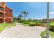 Charming brick paved walkway leading to the canal, with palm trees and lush landscaping at 2741 Via Cipriani # 934B, Clearwater, FL 33764