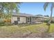Exterior view of the home's screened patio and lush backyard, perfect for enjoying the outdoors at 3058 Cara Ct, Palm Harbor, FL 34684