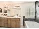 Bathroom featuring double vanities, marble accents, and a luxurious soaking tub at 3058 Cara Ct, Palm Harbor, FL 34684