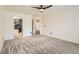 Carpeted bedroom showcasing an ensuite bathroom, fan and multiple entryways for convenience at 3058 Cara Ct, Palm Harbor, FL 34684