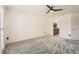 Carpeted bedroom showcasing an ensuite bathroom, fan and multiple entryways for convenience at 3058 Cara Ct, Palm Harbor, FL 34684