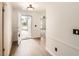 Bright entry with a neutral paint palette, wood look tile, and view to open living area at 3058 Cara Ct, Palm Harbor, FL 34684