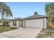 Charming single story home featuring a two car garage, neutral paint, and walkway at 3058 Cara Ct, Palm Harbor, FL 34684