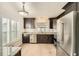 Modern kitchen featuring stainless steel appliances, granite countertops, and dark wood cabinets at 3058 Cara Ct, Palm Harbor, FL 34684