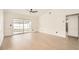 Living room with a sliding glass door, neutral paint and wood look tile flooring at 3058 Cara Ct, Palm Harbor, FL 34684