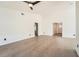 Spacious living room featuring neutral paint, wood look flooring, and an open floor plan at 3058 Cara Ct, Palm Harbor, FL 34684