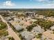 Aerial view displaying the neighborhood with tree-lined streets and the building in the distance at 311 1St Sw Ave, Largo, FL 33770