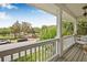Inviting balcony with wooden floors and a comfortable egg chair offers relaxing outdoor living with a view at 311 1St Sw Ave, Largo, FL 33770