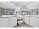 Elegant bathroom with double sink vanity, shower, and lots of mirror reflecting the light at 311 1St Sw Ave, Largo, FL 33770